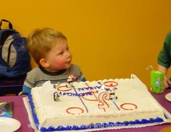 Birthday Party  Kids on Rectangular Sheet Cake Has Been Transformed To A Hockey Ice Rink